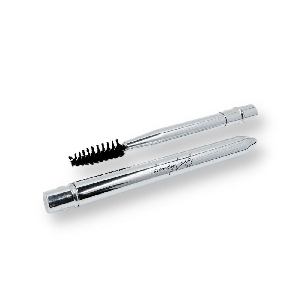 Close-up of a compact eyelash brush with dense bristles, ideal for detailed mascara application and eyelash separation.